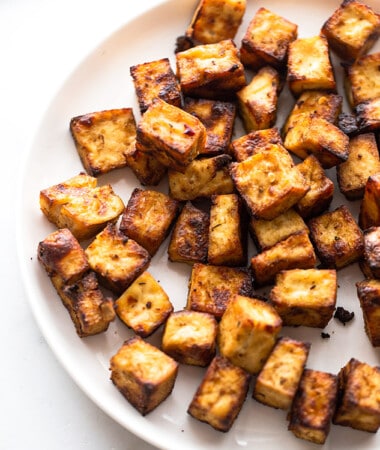 Side view of air fryer tofu cubes on a white plate