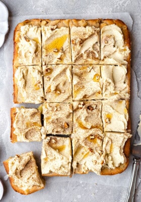 Overhead view of frosted apple cake cut into squares