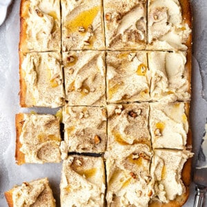 Overhead view of frosted apple cake cut into squares