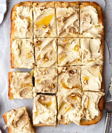 Overhead view of frosted apple cake cut into squares