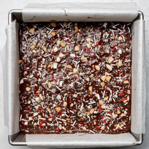 Top view of melted chocolate with sprinkles in a square baking pan