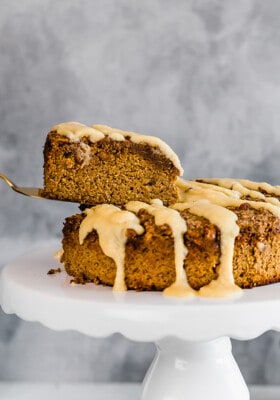 Side view of a slice of healthy pumpkin cake with on a white cake stand