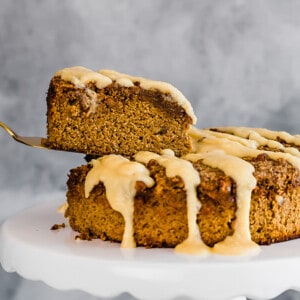 Side view of a slice of healthy pumpkin cake with on a white cake stand