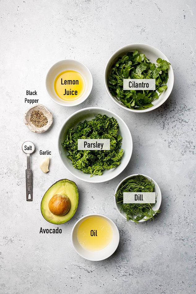 Flat lay of ingredients to make green goddess dressing with text