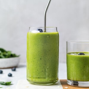 Side angle of one green smoothie in a glass