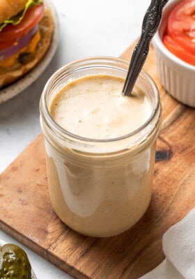 45 degree angle of Whole30 burger sauce in a jar with a spoon in the jar