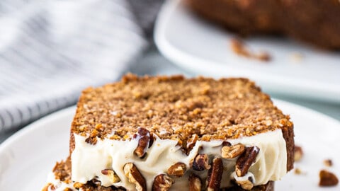 Side view of two slices of keto gingerbread loaf slices on a white plate