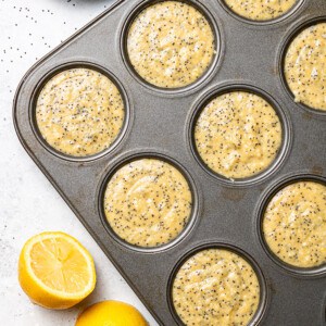 Lemon muffin batter in a 12-cup muffin pan