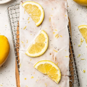 Flat lay of a whole glazed lemon poppy seed loaf on a wire rack