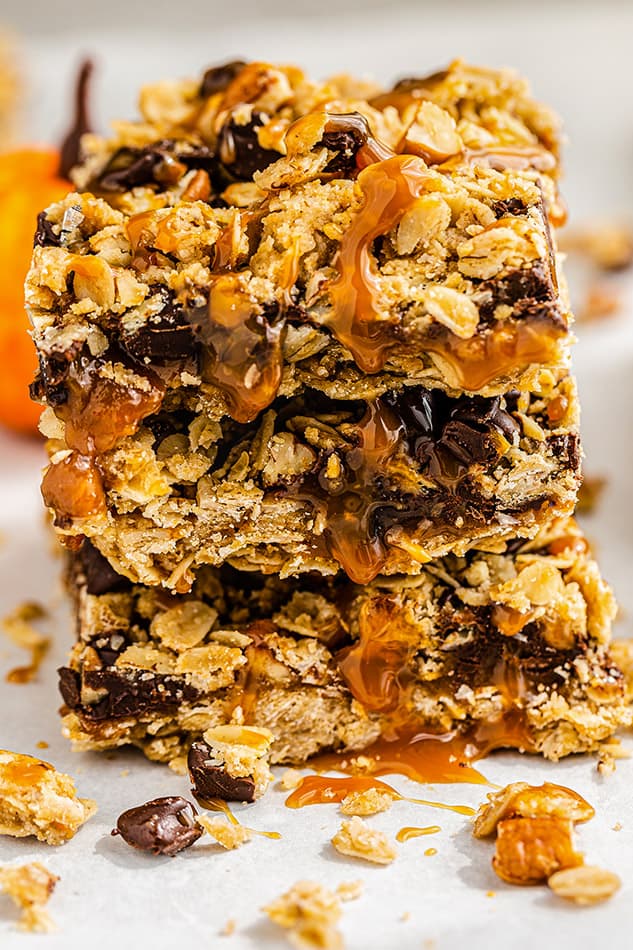 A stack of Pumpkin Oatmeal Bars with caramel drizzle