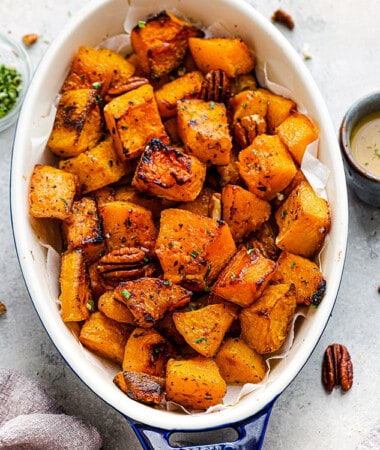 Top view of roasted butternut squash in an oval casserole dish