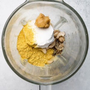 Nutritional yeast, miso, cashews and coconut cream in a blender