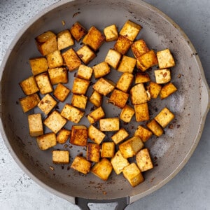 Crispy tofu cubes in a frying pan