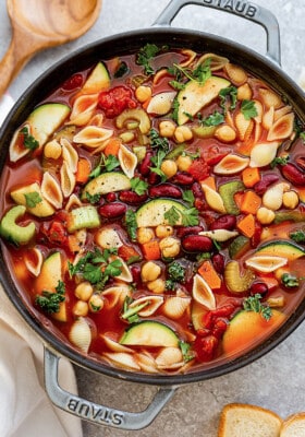 A pot of vegan minestrone soup in a grey cast iron dutch oven