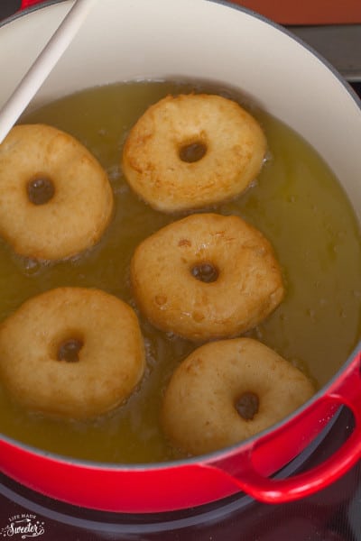Donuts frying in a pan of oil