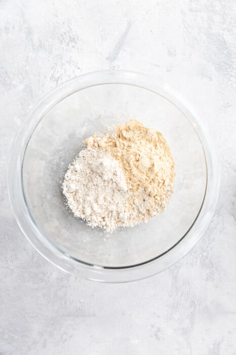 dry ingredients for baked oats in a glass mixing bowl