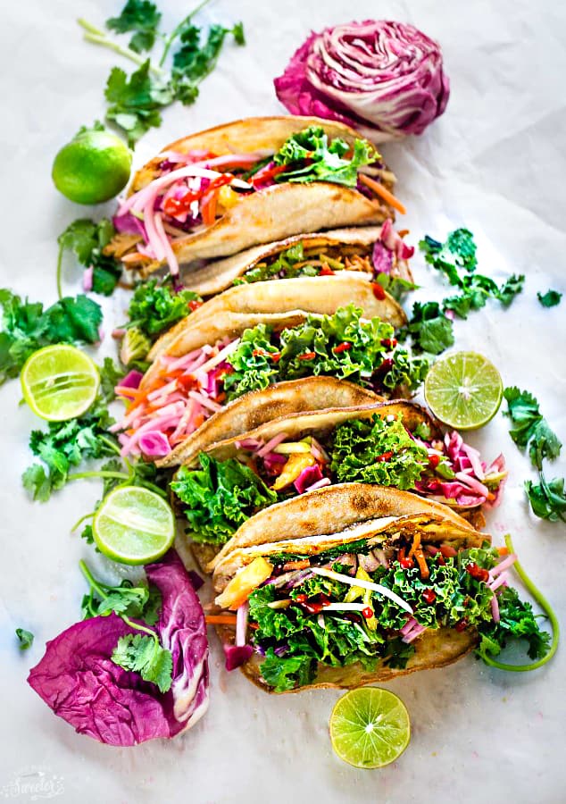 These Asian Tilapia and Kale Slaw Tacos make the perfect light and healthy weeknight meal. Best of all, easy to customize with toasted tortillas topped with flaky white fish fillets (you can use cod, tilapio or sole), a delicious kale slaw with purple cabbage, carrots, daikon and sweet pineapples. Delicious for Taco Tuesday or Cinco de Mayo!