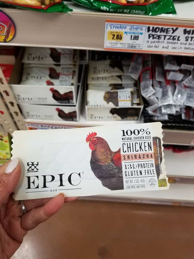 A hand holding an Epic Chicken Sriracha bar