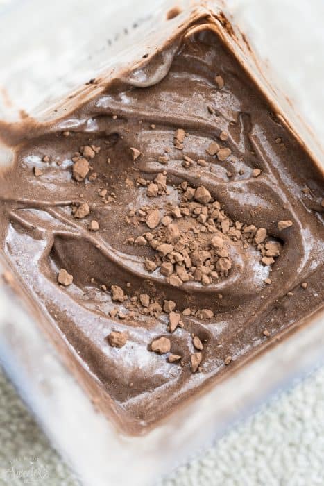 Photo of two ingredient chocolate banana ice cream in blender with chocolate.