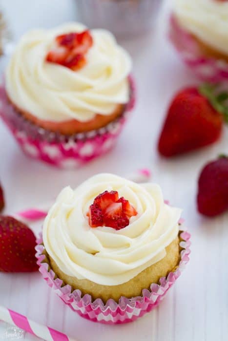 Overhead view of Vanilla Cupcakes topped with diced strawberries