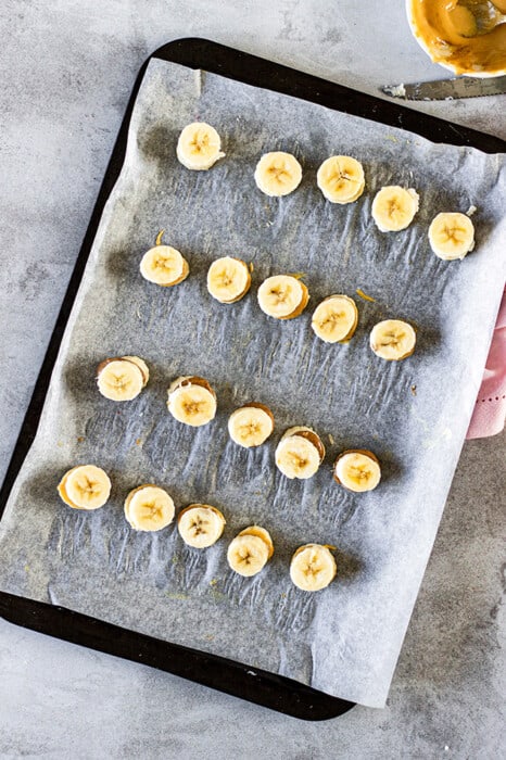 Overhead view of Vegan Banana Bites on a parchment-lined sheet pan