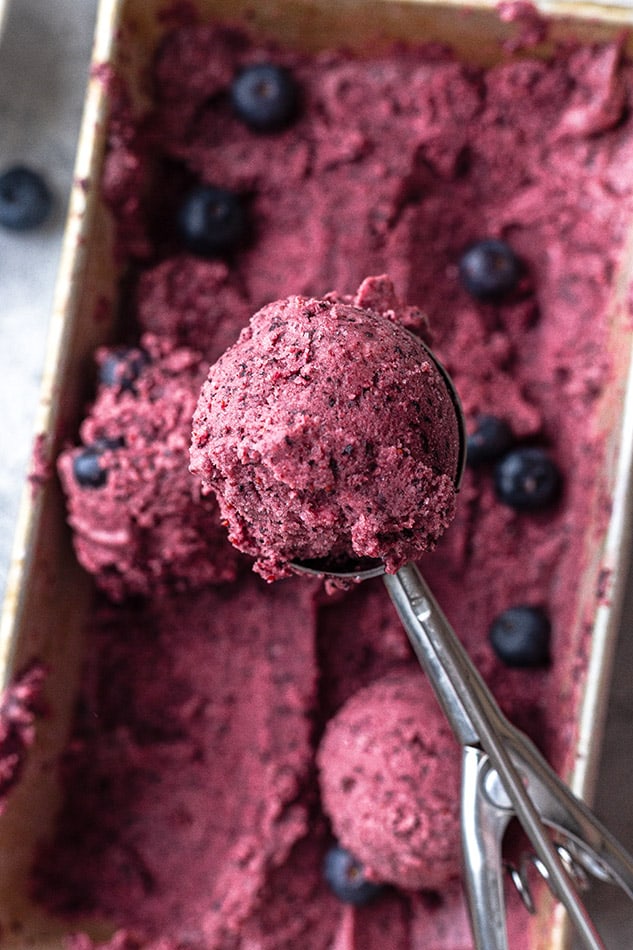 Close-up view of homemade blueberry ice cream in an ice cream scoop