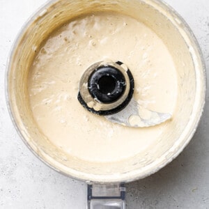 Top view of blended Caesar dressing in a food processor bowl
