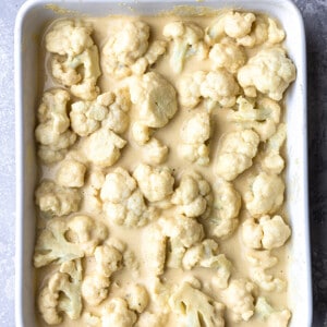 Top view of unbaked Keto Cauliflower Mac and Cheese in a white baking dish