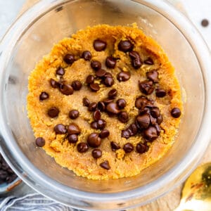 Top view of Keto cookie dough in a clear bowl with a spoon