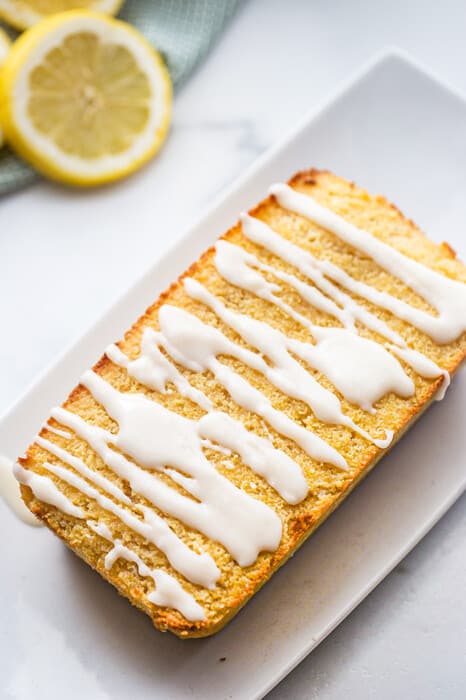 Top view of vegan lemon bread on a white square plate