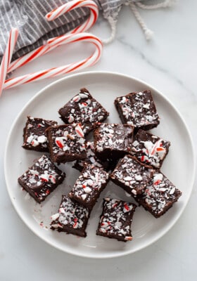 Top view of peppermint fudge squares on a white plate