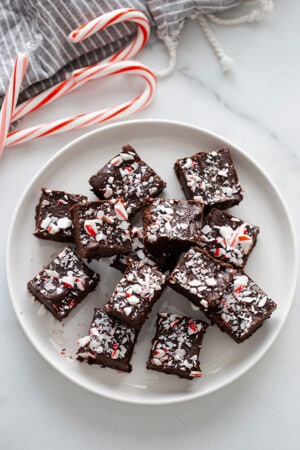 Top view of peppermint fudge squares on a white plate