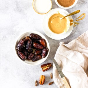 Close-up view of ingredients for making stuffed dates on a grey background