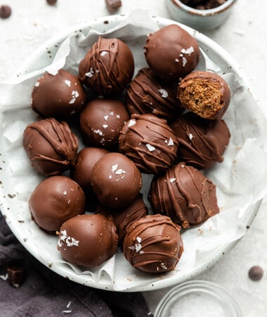 A pile of vegan truffles in a white bowl