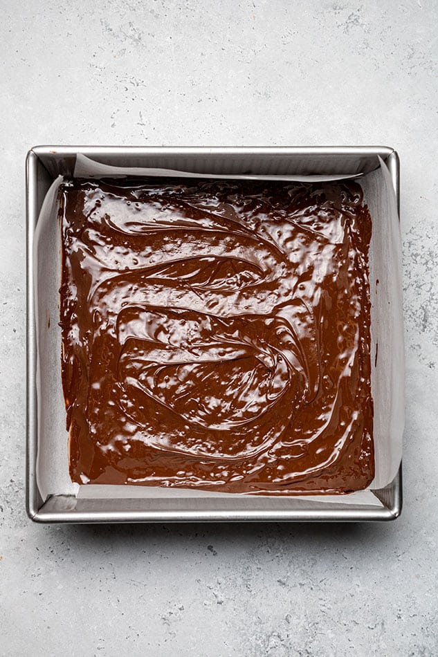Overhead view of melted chocolate in a square pan