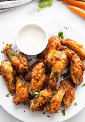 Air Fryer Chicken Wings on a white plate with a side of ranch dip