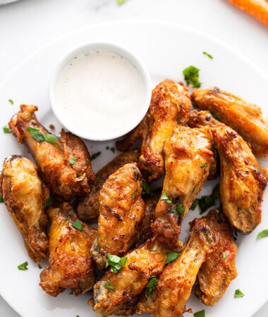 Air Fryer Chicken Wings on a white plate with a side of ranch dip