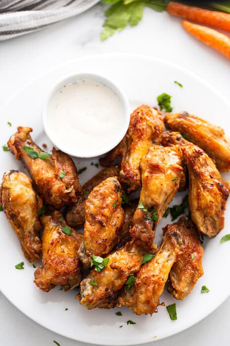 Air Fryer Chicken Wings on a white plate with a side of ranch dip