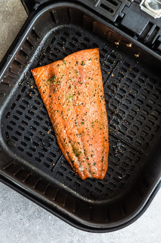 One Large Air Fried Salmon Fillet Sitting in the Basket of an Air Fryer