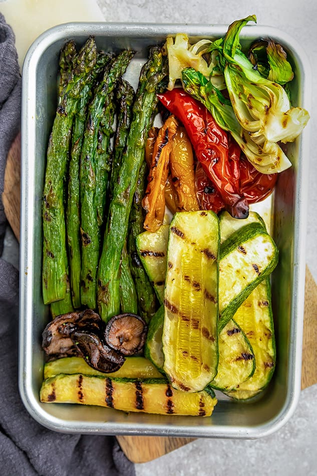 Top view of grilled vegetables on silver tray.