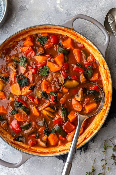 Top view of Whole30 vegetable stew in a pot with a spoon
