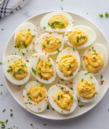 11 deviled eggs on a white plate