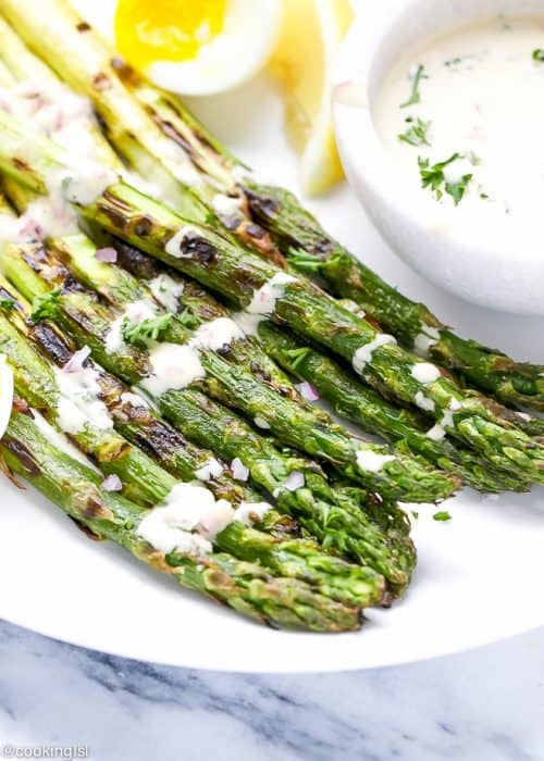 Grilled asparagus spears drizzled with dijon mustard vinaigrette
