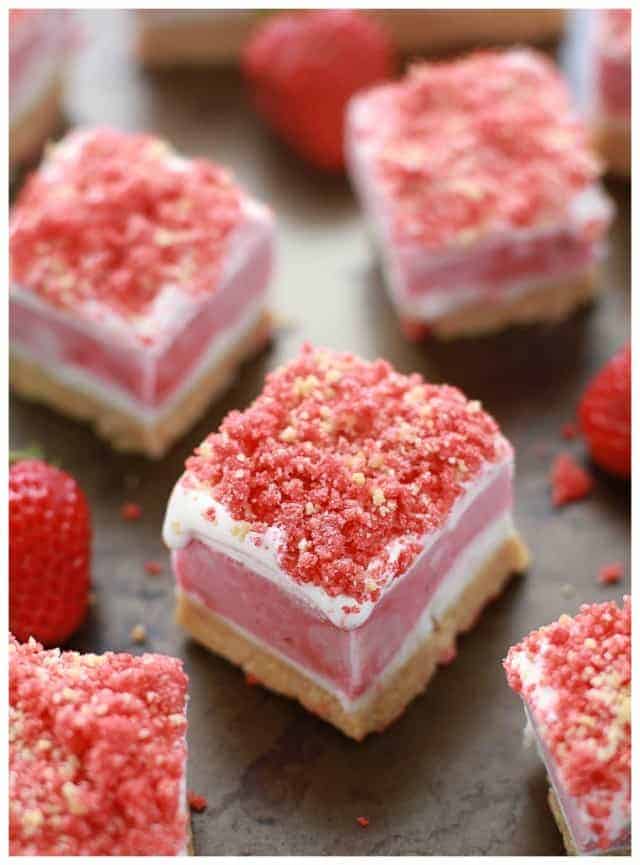 Strawberry Shortcake Ice Cream Bars on grey surface with fresh strawberries.
