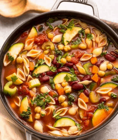 A pot of easy minestrone soup in a grey cast iron dutch oven