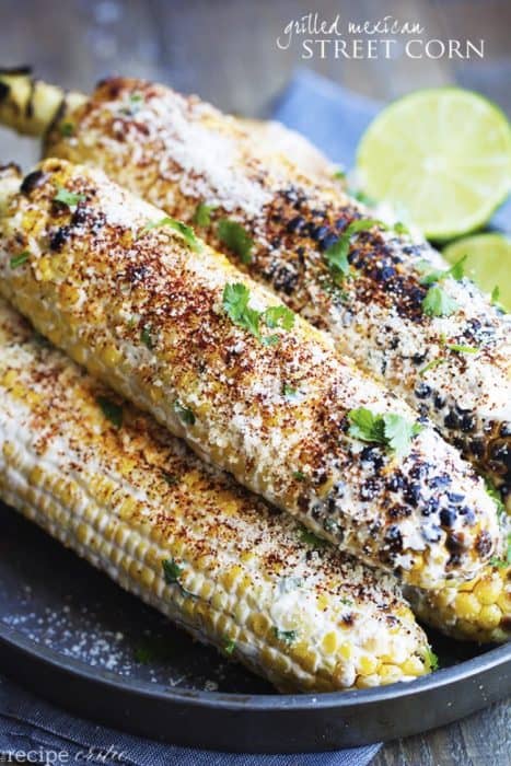 Grilled Mexican Street Corn stacked on a plate