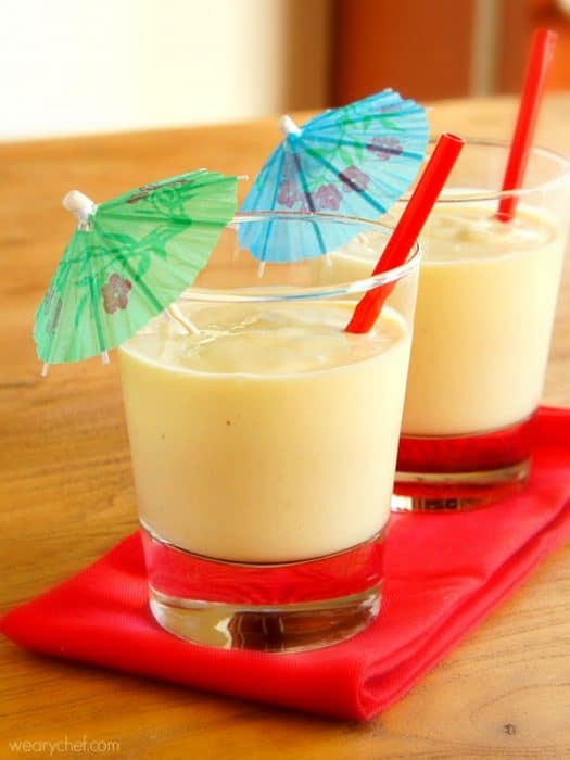 Two Tropical smoothies in glasses with paper umbrellas